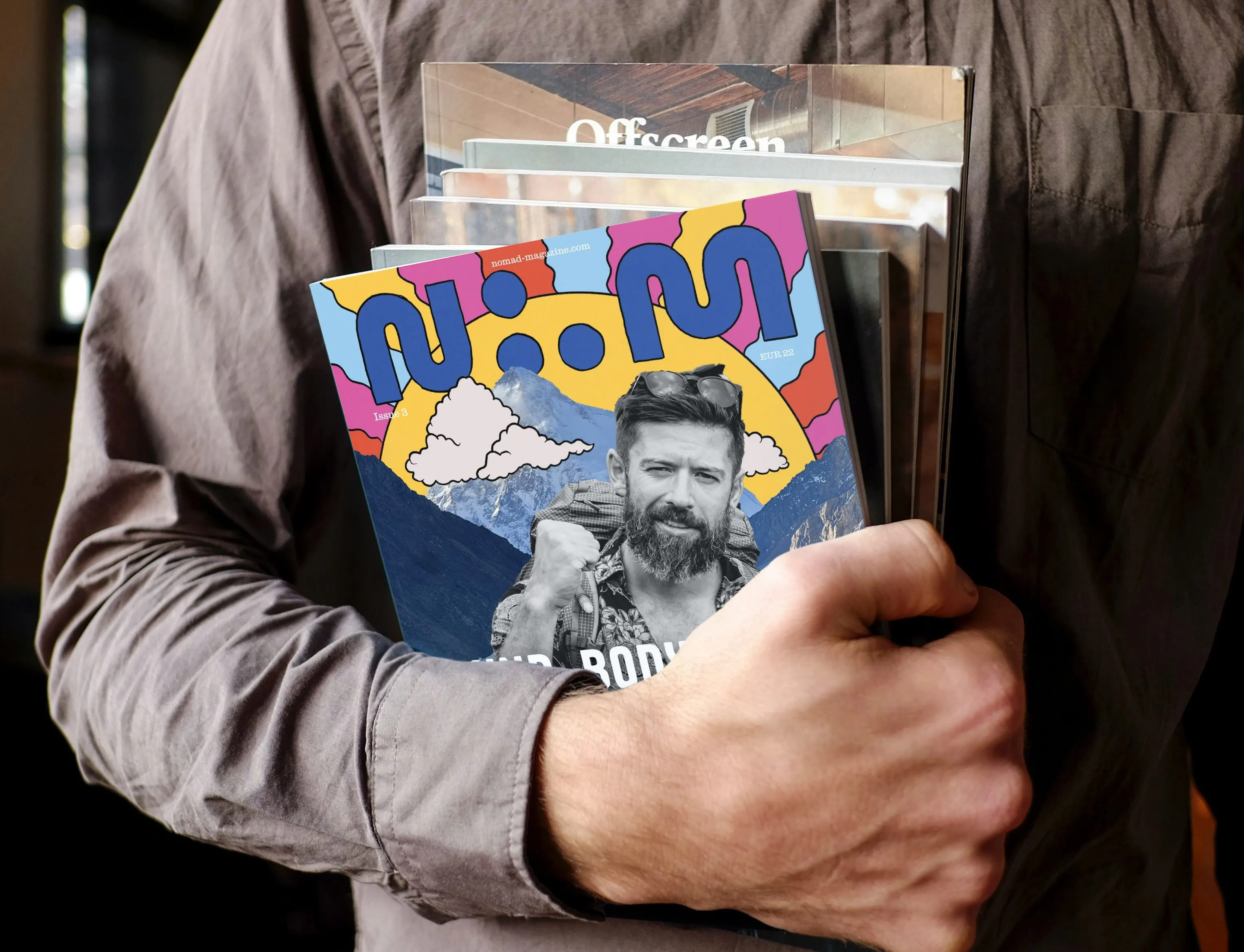 Person holding Nomad Magazine issues