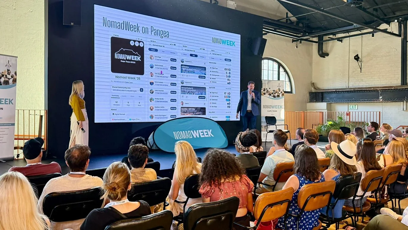 Nomad Week Cape Town stage with large screen showing NomadWeek on Pangea app and speakers addressing the audience