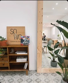 Nomad Magazine displayed inside a coworking space with lounge and tables visible behind