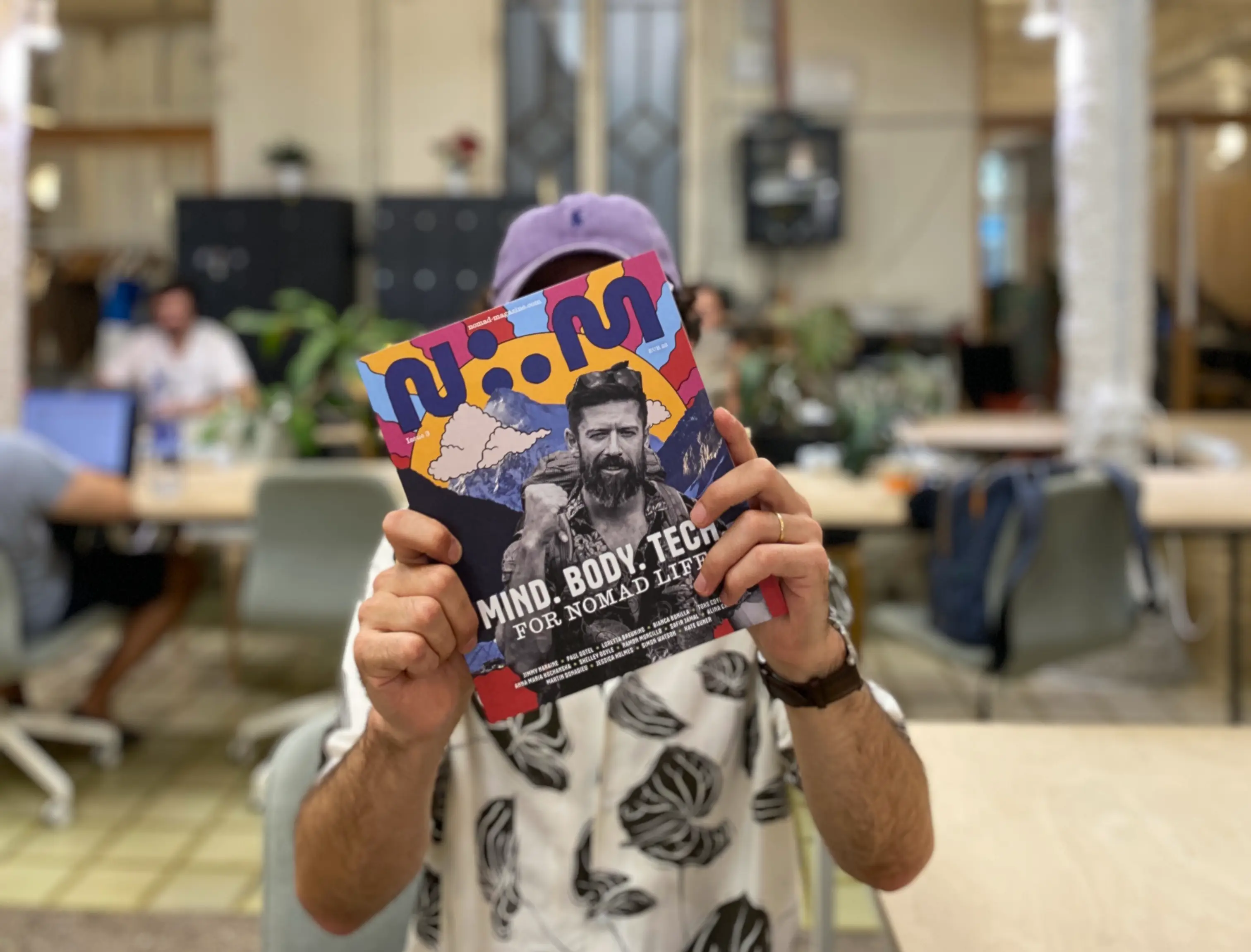 Person holding Issue 3 of Nomad Magazine with Mind, Body, Tech theme