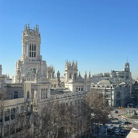 View from a Madrid coworking terrace toward the Palacio de Cibeles and Calle de Alcalá