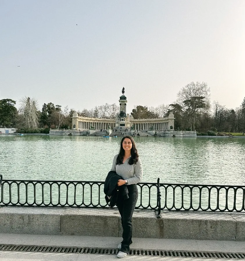 Salina Owens at the Retiro Park lake in Madrid, the Alfonso XII monument across the water