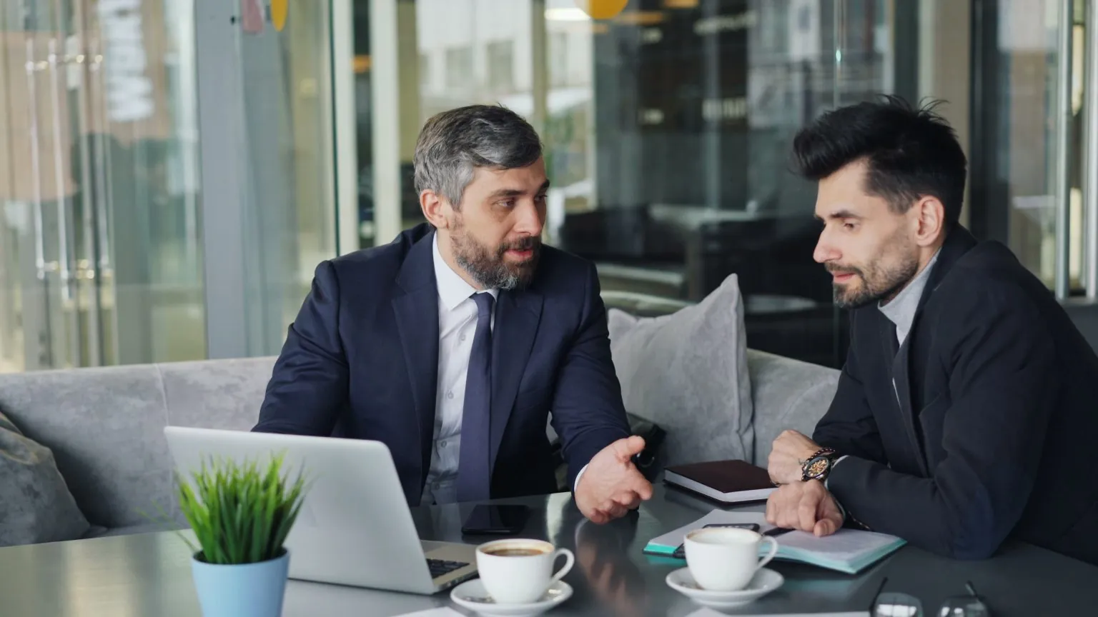 CPA meeting with a client to review tax documents on a laptop